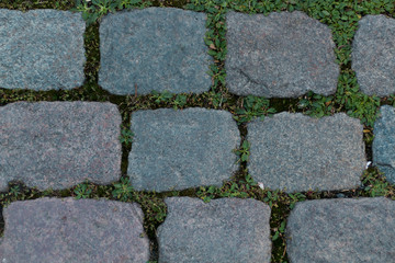 Granite cobblestoned street in a old town background