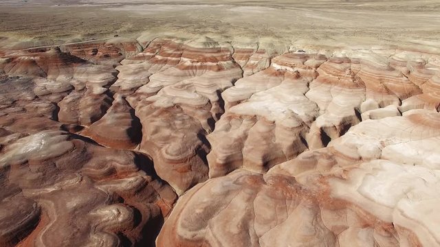 Rising aerial view over eroded desert in the desert with Mars like landscape in Utah.