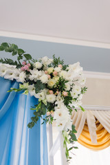 wedding arch is decorated with fresh flowers of different colors