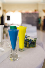 several glasses of sand for a sand ceremony stands on a table