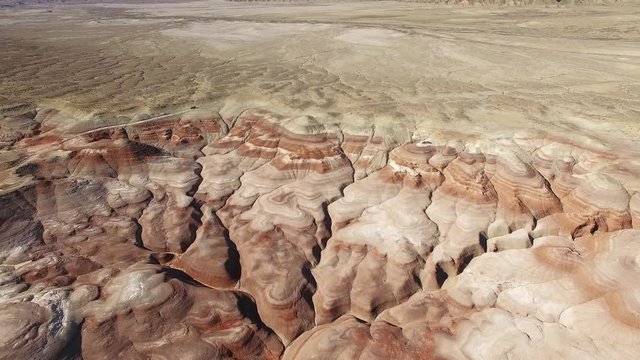 Aerial view flying high above the desert landscape viewing eroded section showing red dirt in Utah.