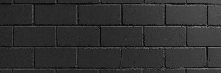 Black painted brick wall for background, black texture