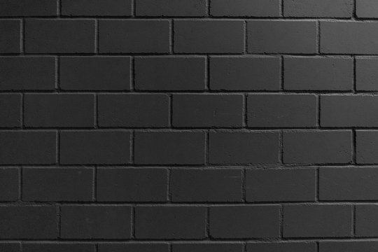 Black painted brick wall for background, black texture