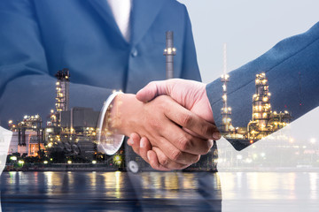 Double exposure of handshake and refinery plant, business teamwork and connection concept 