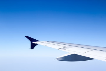 Fototapeta na wymiar On flight, in the blue sky background
