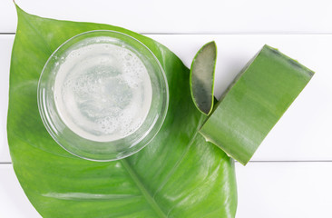 Top view of fresh aloe vera leaves and aloe vera juice
