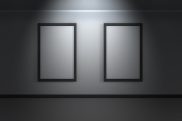 Two empty white frames on the white wall in dark room with spot light above - 3d rendering