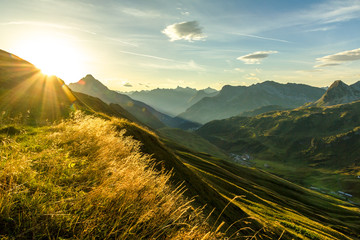 Beautiful sunrise and layered mountain silhouettes in early morning. Lechtal and Allgau Alps,...