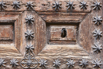 Antique decorated wooden door keyhole. Vintage background