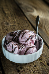 Balls of berry ice cream on a wooden table