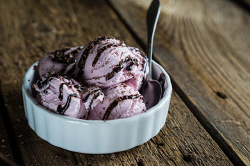Balls of berry ice cream on a wooden table