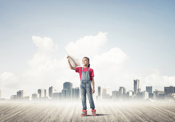 Concept of careless happy childhood with girl dreaming about fut