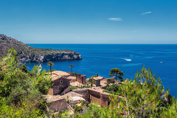 Naklejka na ściany i meble View of small village at the coastline of Deia, Mallorca Spain