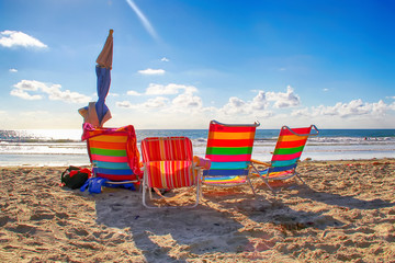 Four colorful beach chairs in San Diego, California