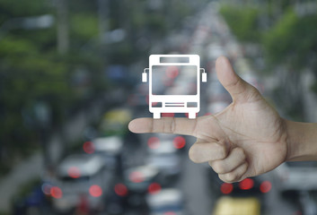 Bus flat icon on finger over blur of rush hour with cars and road, Business transportation service concept