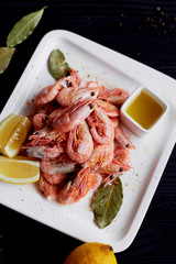 Boiled shrimp with pepper and Lavrushka. With the lemon slices and sauce
