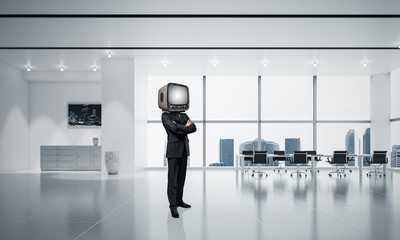 Businessman with an old TV instead of head.