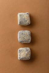 Top view of handmade chocolate truffles in cocoa powder on colored background