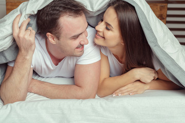 beautiful couple lying together on the bed