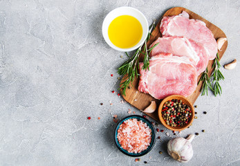 Fresh raw pork chops with spices and herbs