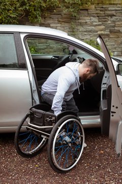 Disabled man on wheelchair boarding in his car