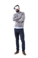 Young smart casual man wearing vr glasses with crossed arms. Full body isolated on white background. 