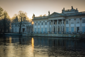 Fototapeta na wymiar Sunrise over the Royal Palace on the Water in Lazienki Park in Warsaw, Poland