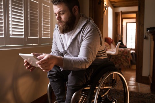 Disabled man using digital tablet