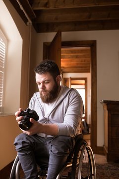 Disabled man looking at photos in camera