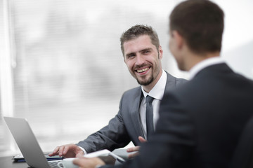 closeup.business colleagues sitting at a Desk.