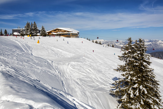Panoramic view of ski slope in winter sunny day at the mountain ski resort of Alpbachtal, Wildsch&ouml;nau, Austria. People skiing down the hill.