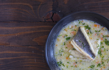 fish soup on dark background