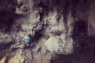 Rock-climbing in Turkey. The climber climbs on the route. Photo from the top.