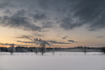 Fototapeta na wymiar Winter landscape. Chimney and smoke in background.