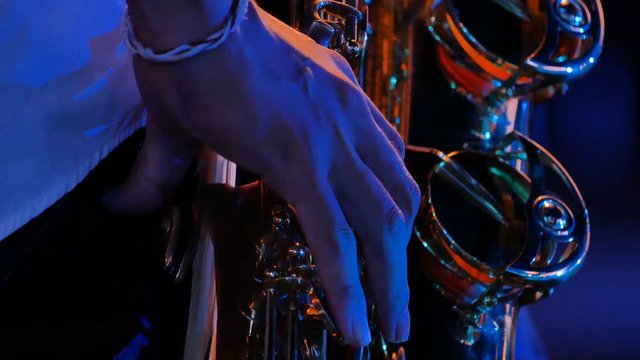 4K Closeup Saxophonist plays on golden saxophone. Live Jazz music
