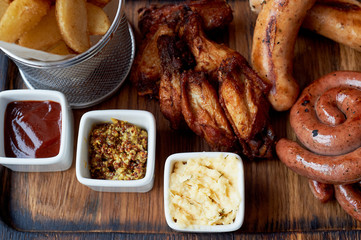 German hearty lunch in the pub. Grilled sausages, stewed cabbage, croutons, sauce. Beer snack