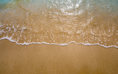 White bubble of Sea wave on the beach
