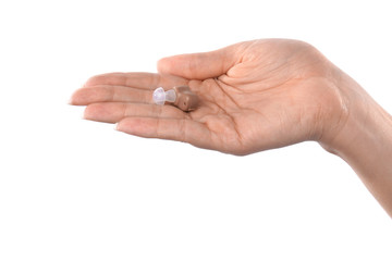 Woman holding hearing aid on white background