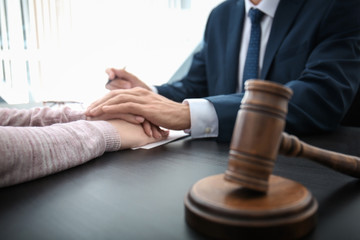 Lawyer having meeting with client in office, closeup