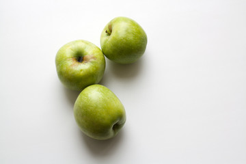 Three ripe green apples isolated on white background
