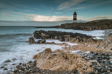 Fototapeta na wymiar Low tide at the Trwyn Du lighhouse at Penmon Point in Anglesey, North Wales.