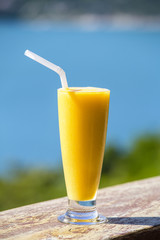 Fresh organic Mango shake in thai restaurant on the beach near sea , Thailand. Close up