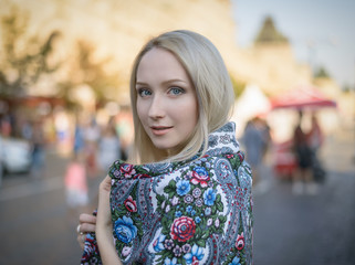 Outdoors portrait of beautiful young woman in the street. Selective focus.