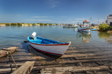 Traditional Portuguese boat with a motor on the dock.