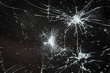 Obraz premium Cracked smart phone screen close-up. Broken glass texture background