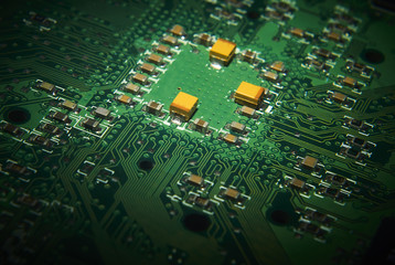 Electronic computer circuit board close up.
