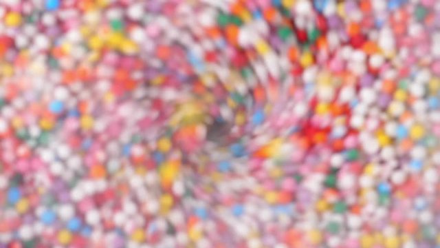 Colorful sprinkles sugar candy fly after being exploded in blender. Close-up shot.
