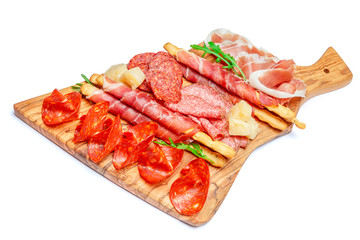 Cold smoked meat plate with pork chops, prosciutto, salami and bread sticks