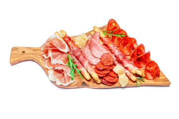 Cold smoked meat plate with pork chops, prosciutto, salami and bread sticks