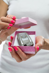 lovely little gift box with a car key in the beautiful manicured hands girls 